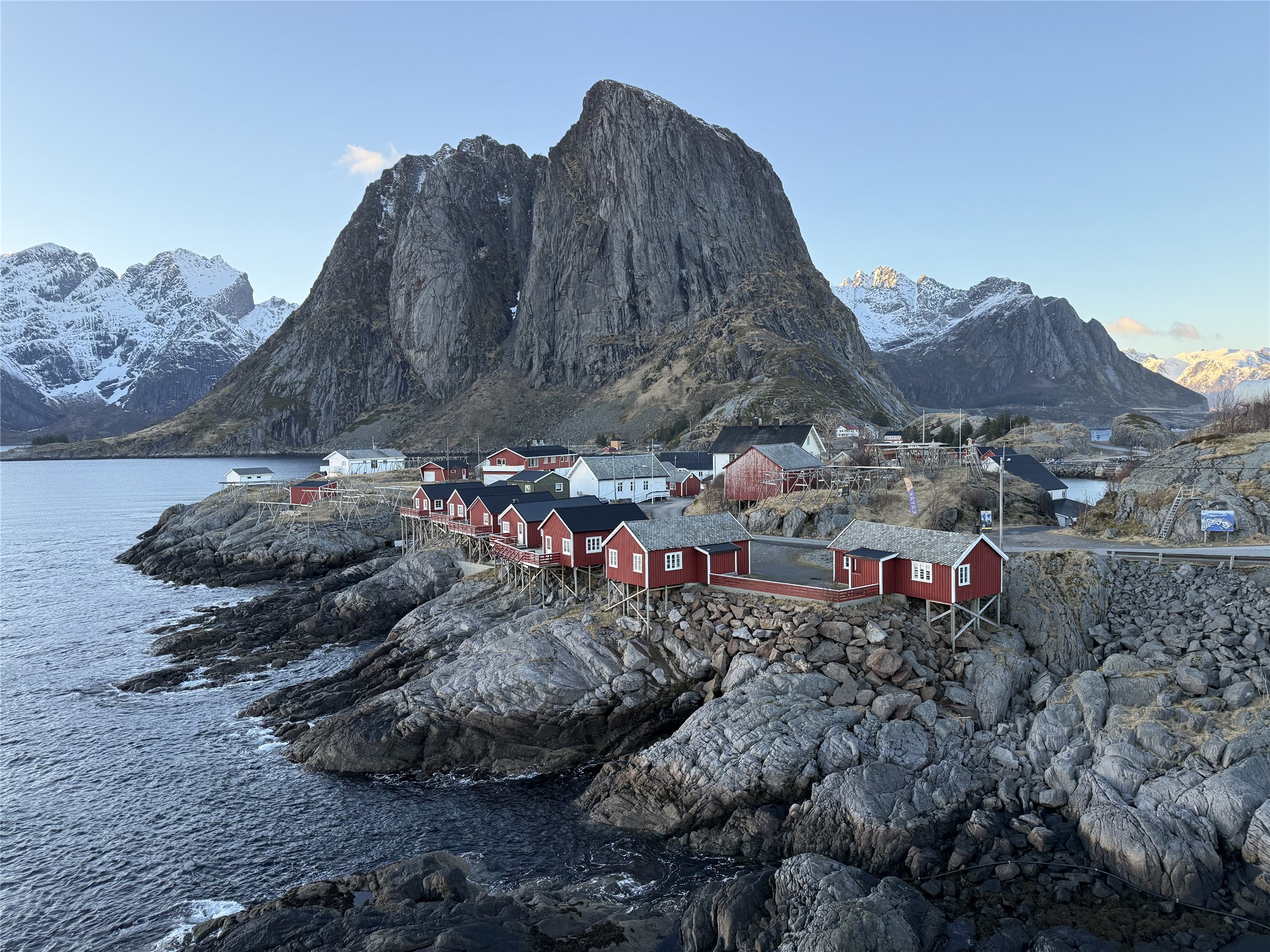 Red fishing cabins beneath Lofoten mountains