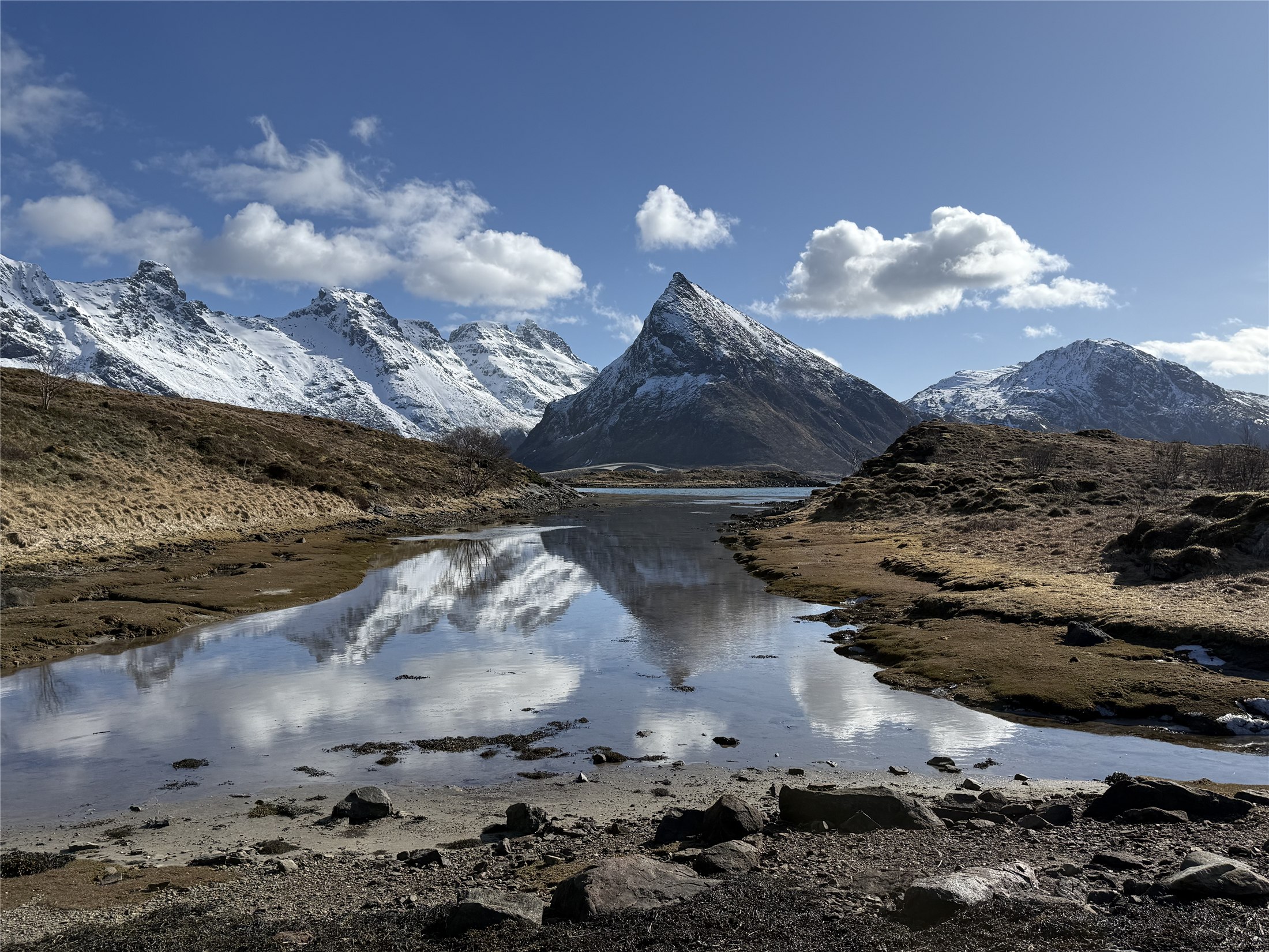 Snowy Lofoten mountain reflected in water