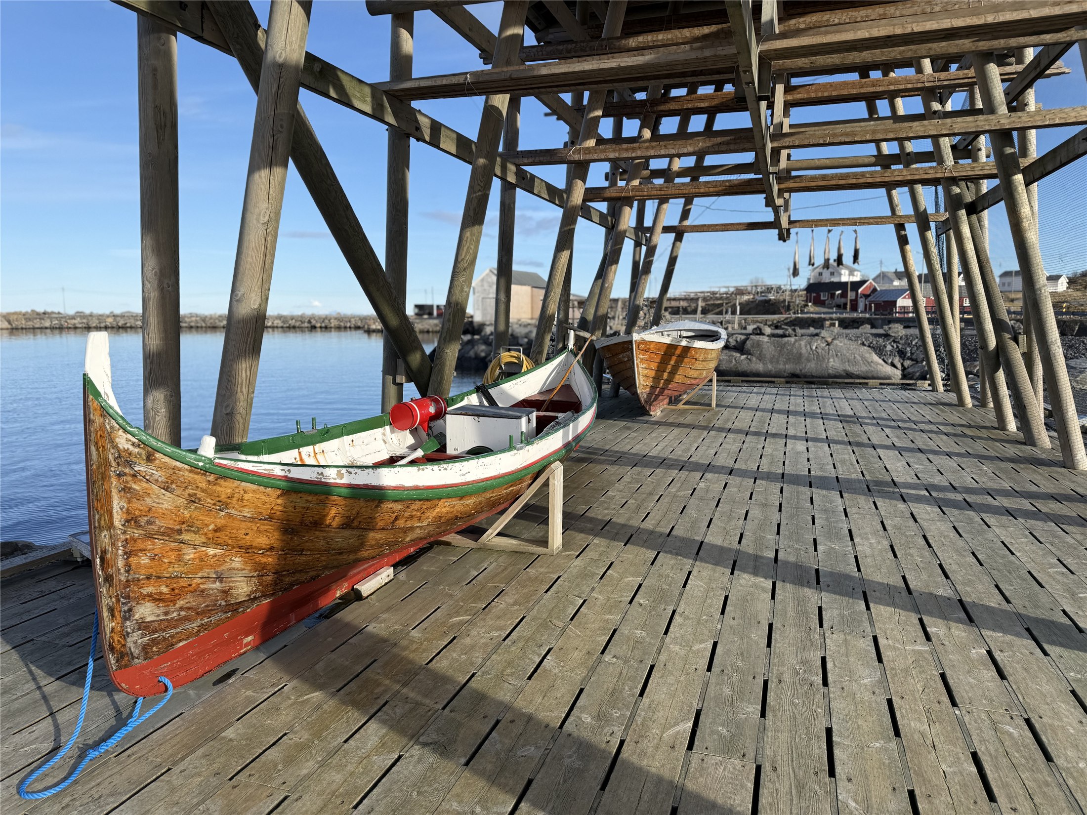 Boats beneath a fish-drying rack in Lofoten